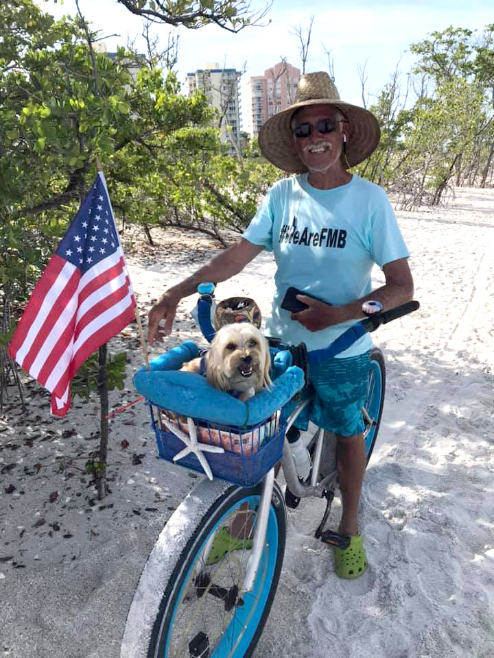 bicyclist-with-his-doggies-on-the-beavh-wearing-a-WeAreFMB-tshirt