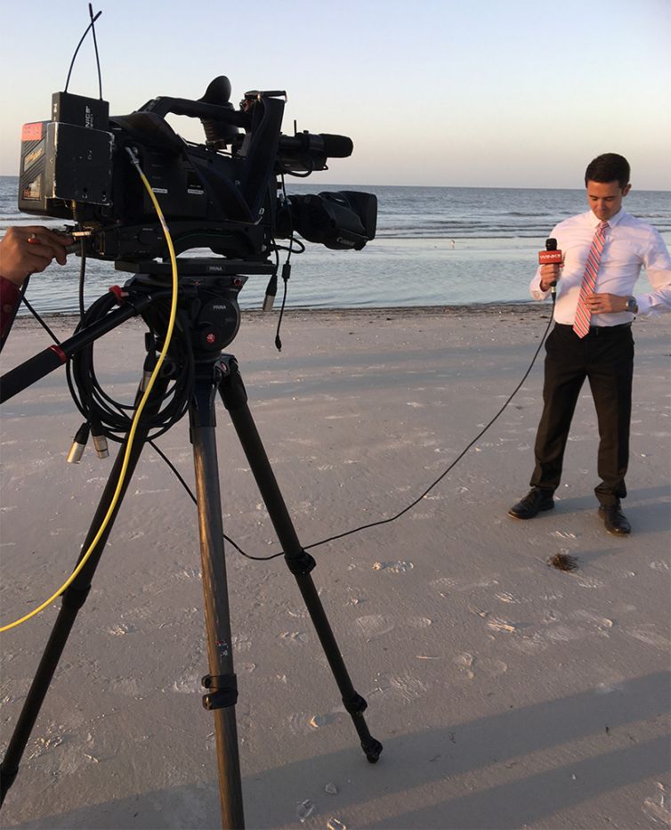 news reporter broadccasting from on fort myers beach